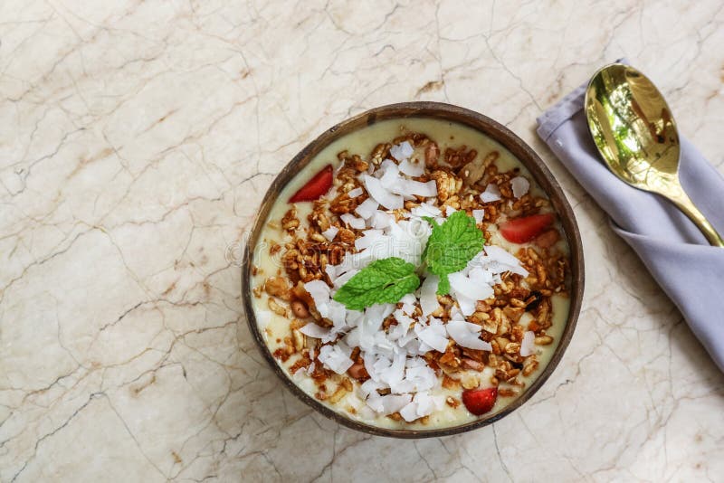 Smoothie Bowl with Mango, Yogurt, Granola and Strawberry Stock Photo