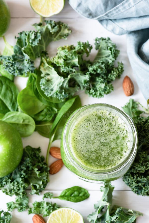 Smoothie detox with green fruits, vegetables, spinach and kale on white