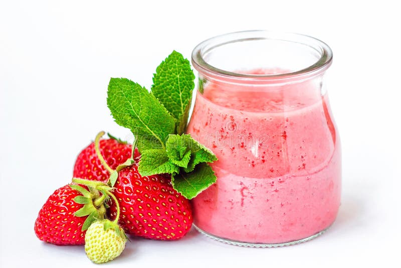 Smoothie or milkshake in glass jar with fresh strawberry fruits and mint isolated on white background, healthy food for breakfast,