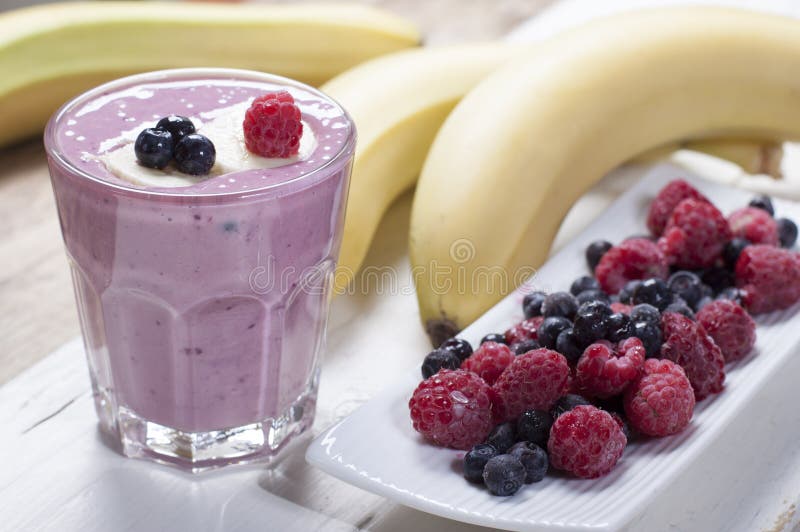 Smoothies of frozen raspberries, blueberries and banana with yo