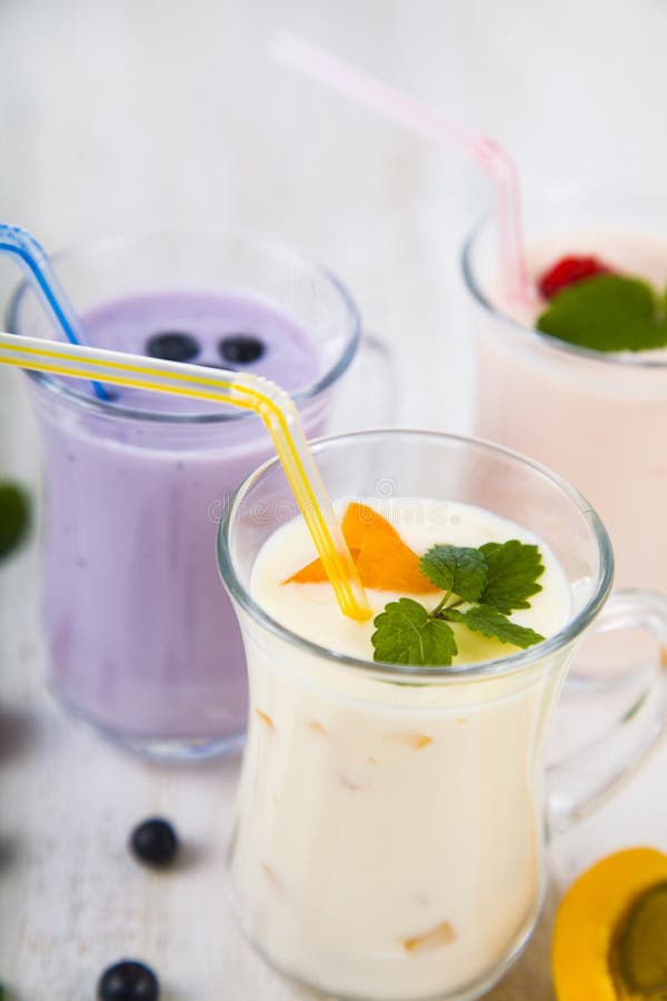 Smoothies or yogurt with fresh berries. Milkshakes with raspberries, blueberries, apricots and mint leaves.