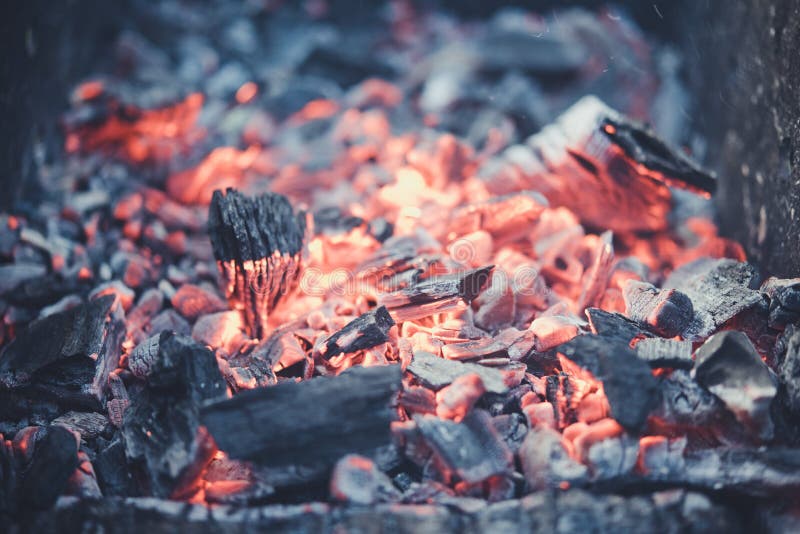 Smouldering coals at barbeque campfire