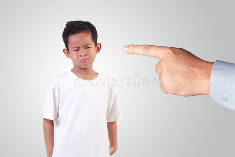 Portrait of Sad Asian boy with black hair wearing white shirt crying for being punished by his old man. Portrait of Sad Asian boy with black hair wearing white shirt crying for being punished by his old man