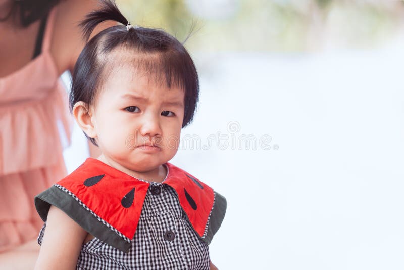 Sad asian baby girl crying and upset in her house. Sad asian baby girl crying and upset in her house