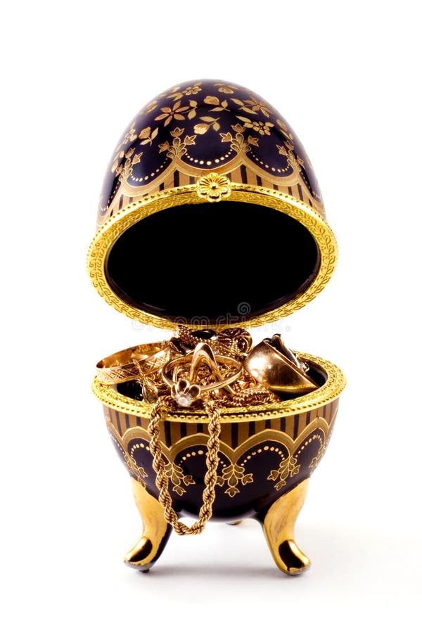 Gold ornaments are photographed in a casket in the form of egg. Gold ornaments are photographed in a casket in the form of egg