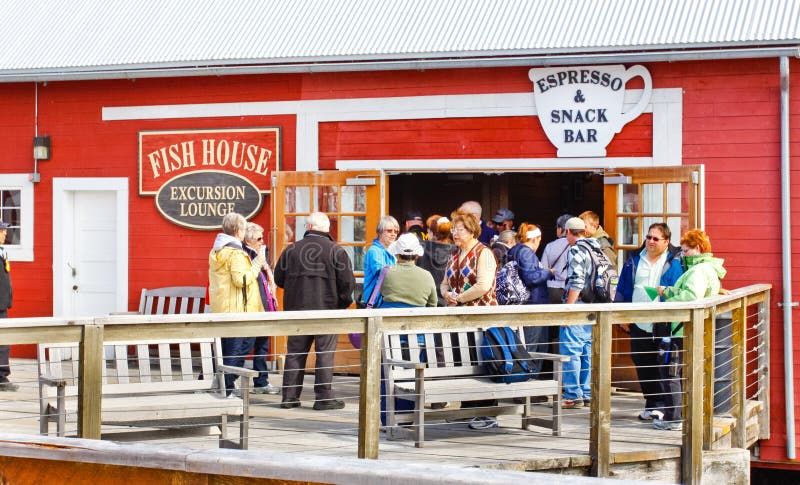 Cruise ship visitors exploring the Fish House excursion lounge Espresso & Snack Bar just outside of the Icy Strait Point Hoonah Packing Company old historic cannery and cruise ship visitors welcome center near Hoonah, Alaska on Chichagof Island. Icy Strait Point itself is owned by local native Tlingit tribe members, and Hoonah is the largest Tlingit community in the Pacific Northwest. Cruise ship visitors exploring the Fish House excursion lounge Espresso & Snack Bar just outside of the Icy Strait Point Hoonah Packing Company old historic cannery and cruise ship visitors welcome center near Hoonah, Alaska on Chichagof Island. Icy Strait Point itself is owned by local native Tlingit tribe members, and Hoonah is the largest Tlingit community in the Pacific Northwest.