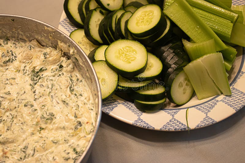 Snack of fresh spinich dip near plate of green vegetables on table royalty free stock image Snack of fresh spinich dip near plate of green vegetables on table royalty free stock image