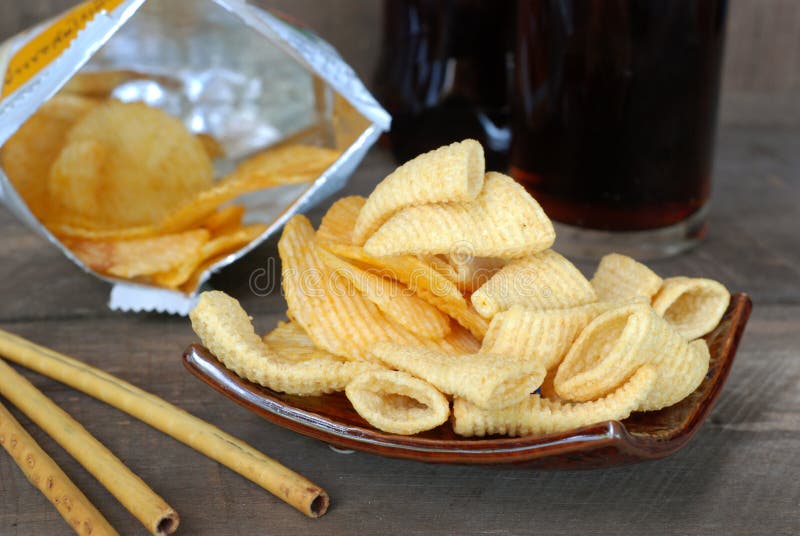 Snack Potato Crisp Corn Chips. on the Old Wooden Floor Stock Photo