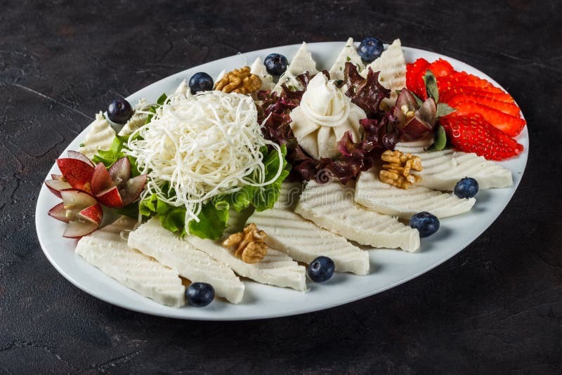 Snack from various white cheeses, cheeses, brynza with strawberries and blueberries stock photography Snack from various white cheeses, cheeses, brynza with strawberries and blueberries stock photography