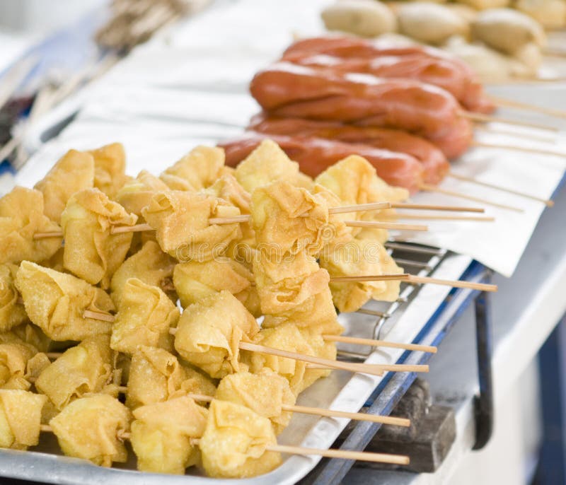 Fried wonton and sausages on bamboo sticks sold by street vendor in bangkok, thailand. Food vendor sold stock images, royalty-free photos and pictures