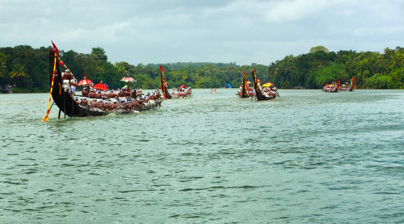 People in traditional dress rowing the snake boats in Aranmula boat race in Kerala, India. People in traditional dress rowing the snake boats in Aranmula boat race in Kerala, India