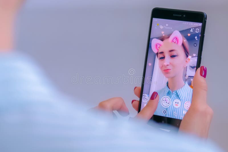 Snapchat multimedia messager with 3d face mask filter on smartphone
