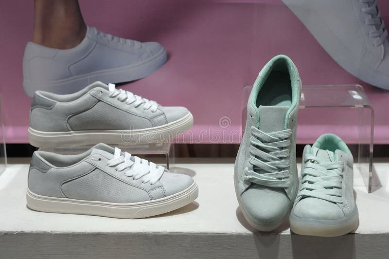 Sneaker shoes on display. A photo taken on two pairs of sneaker shoes on display behind a glass panel stock image Sneaker shoes on display. A photo taken on two pairs of sneaker shoes on display behind a glass panel stock image