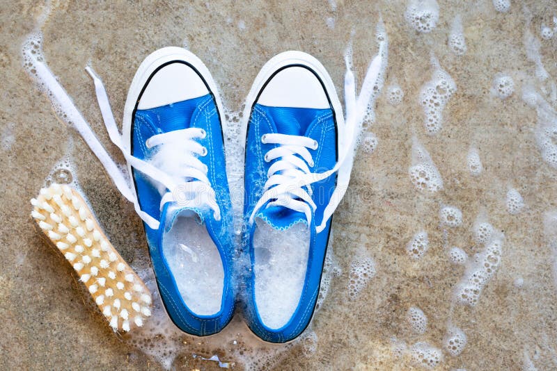 Sneakers with Foam of Powder Detergent Water Dissolution on Blue ...