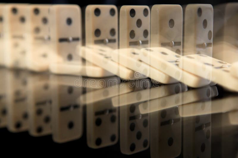 Domino falling effect on black background. Domino falling effect on black background