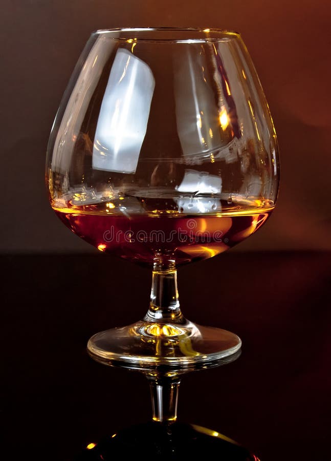 Snifter of Brandy in Elegant Typical Cognac Glass on Dark Background