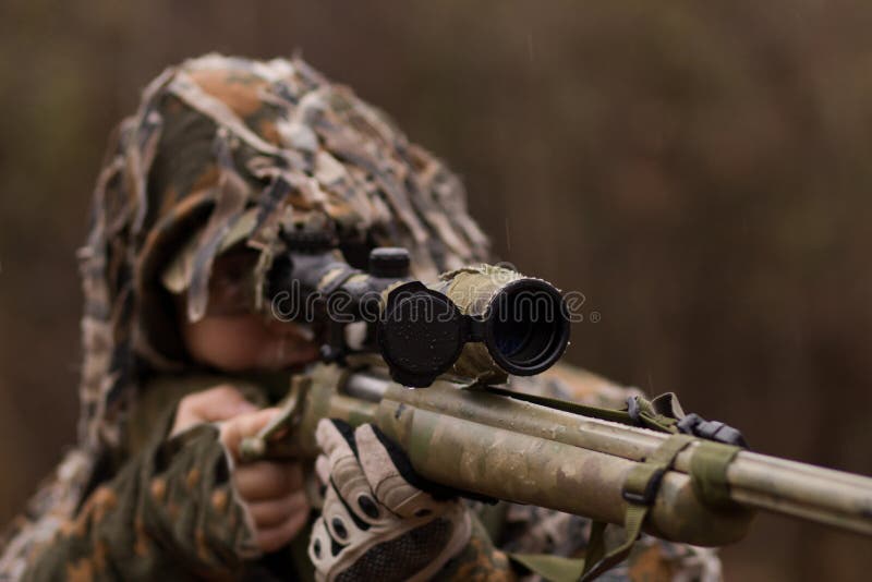 A Camouflaged Sniper Sitting In The Woods Aiming Through His Scope Stock  Photo, Picture and Royalty Free Image. Image 42659284.