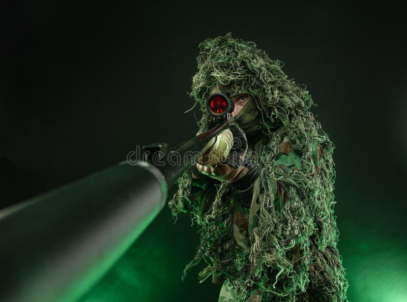 A Sniper In A Camouflage Suit Poncho And Gas Mask With A Sniper