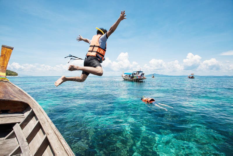 Snorkeling divers jump in the water stock photos