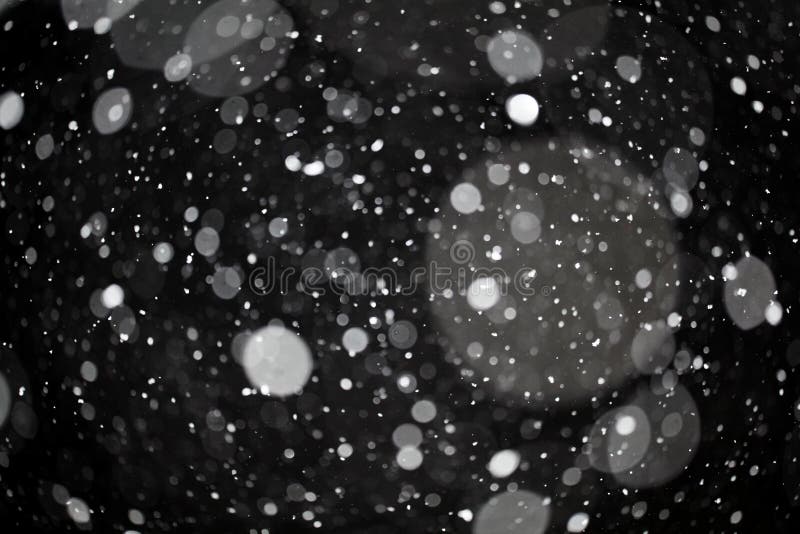 Snow bokeh texture on black stock images
