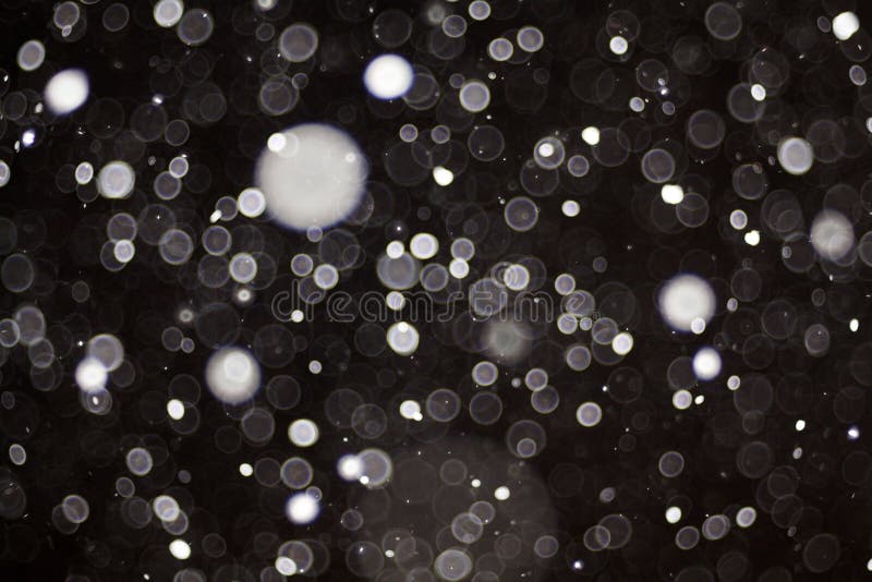 Snow bokeh texture on black background royalty free stock photos