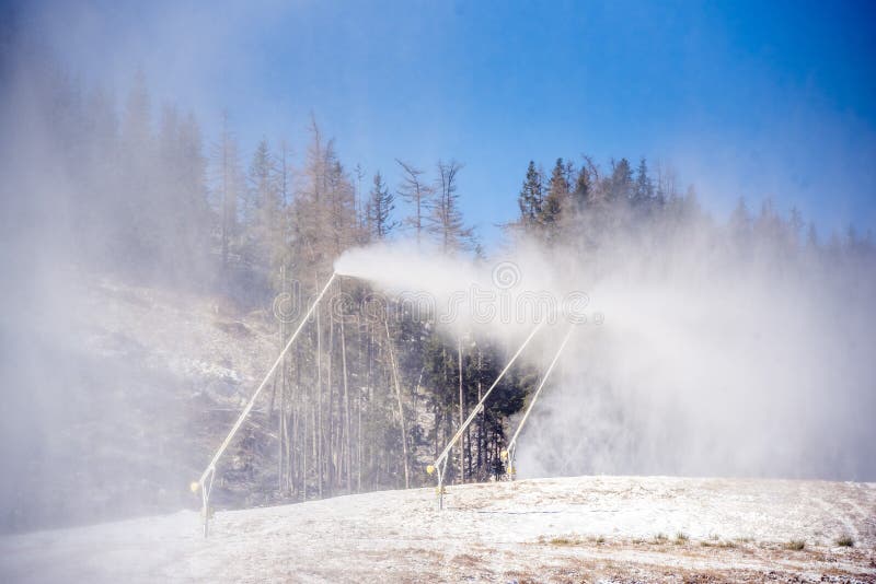 Snow Cannon in Winter Mountains. Snowgun Spraying Artificial Ice