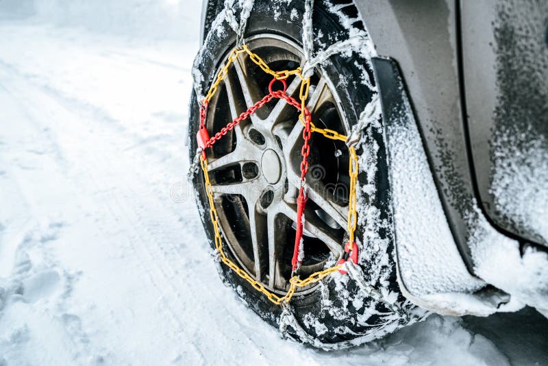 Snow chains on tire at winter road