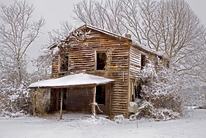 Snow covered abandoned house