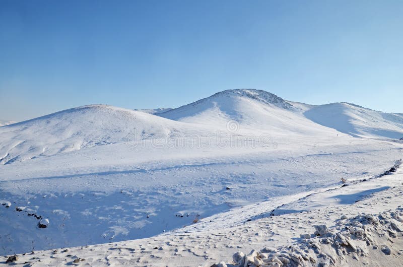Snow-covered hills. Mongolian winter landscape