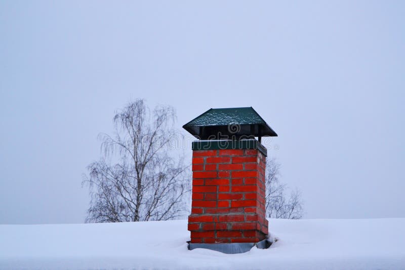 snow-covered old red brick chimney
