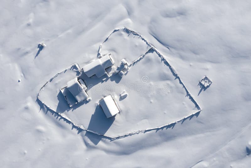 Snow covered remote farm. Aerial view