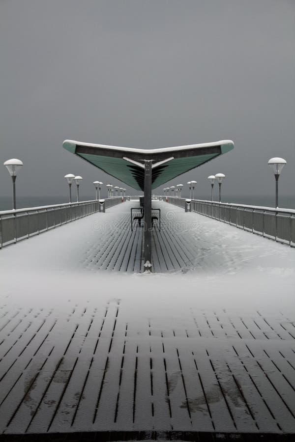 Snow covered retro pier at boscombe