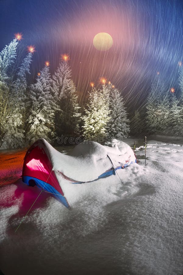 Snow-covered tent of tourists climbers
