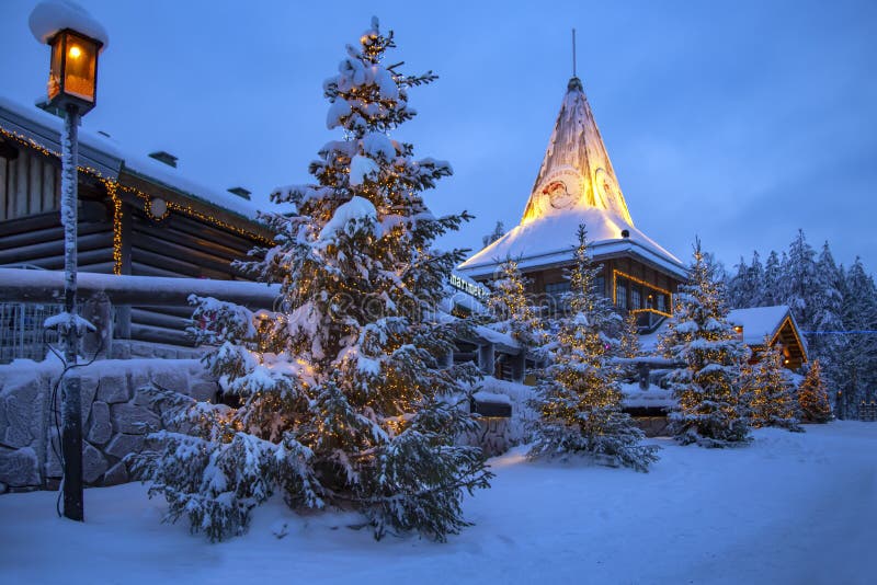 Snow covered wooden buildings in Santa Office at Santa Claus Village