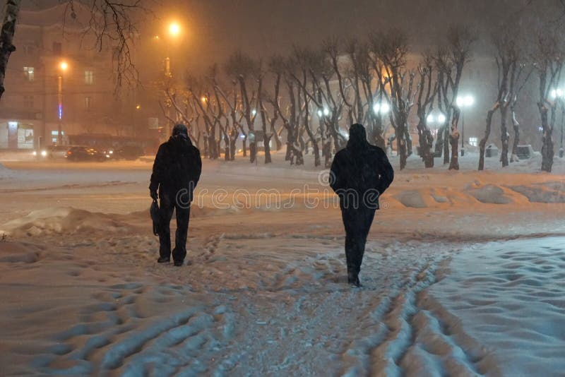 Snow cyclone people passers-by go through the snow