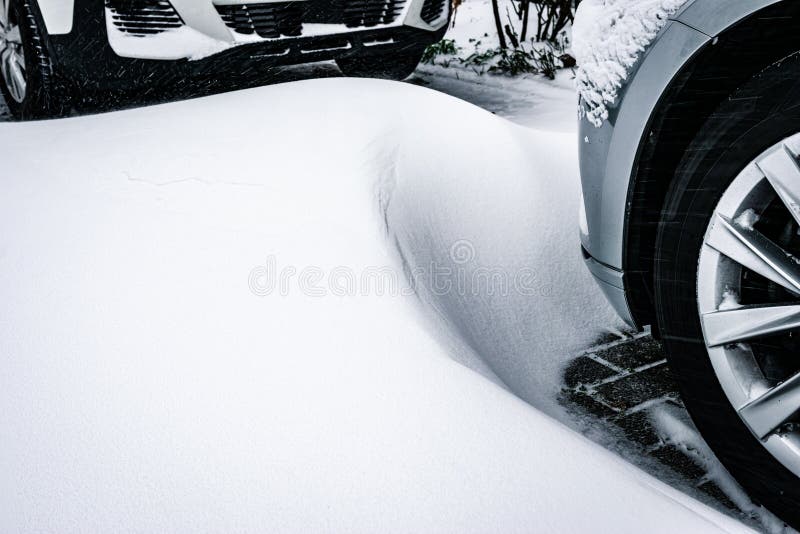 Snow dune near the wheel of a car royalty free stock photography