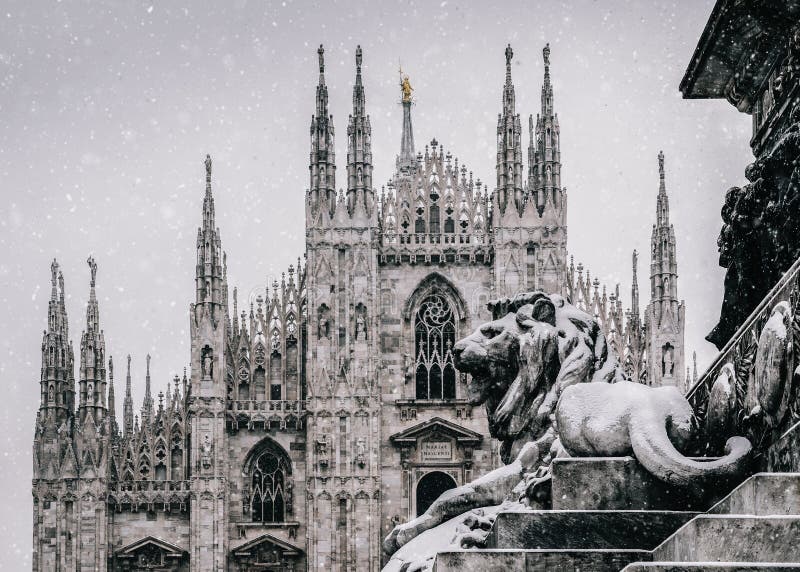 Snow falling at Piazza del Duomo in Milan, Lombardy, Italy with Milan`s landmark Cathedral in background