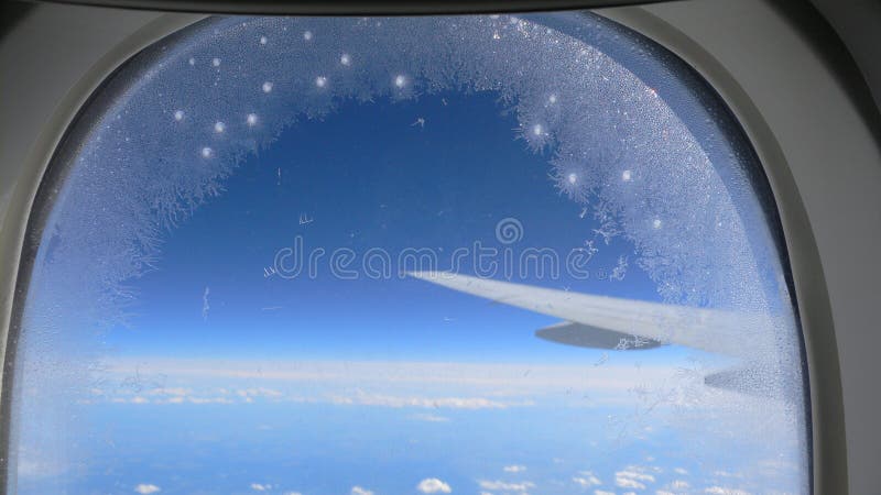 Snow flakes on Jet plane s window