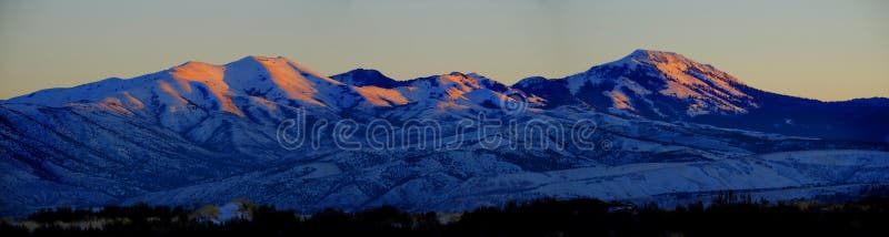 Snow Mountains With Golden Sunlight