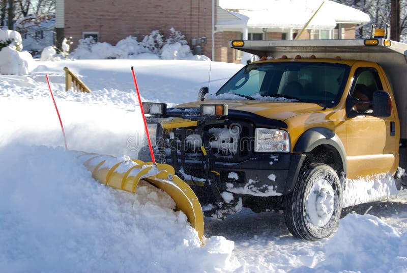 The Snow Plow. Local snow plow clearing the road after a heavy snow storm The Snow Plow. Local snow plow clearing the road after a heavy snow storm