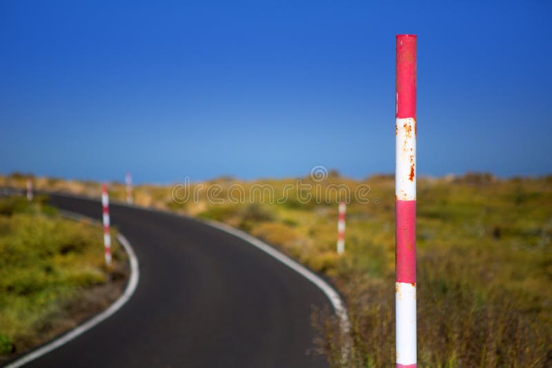 Snow road poles in high mountain blue sky