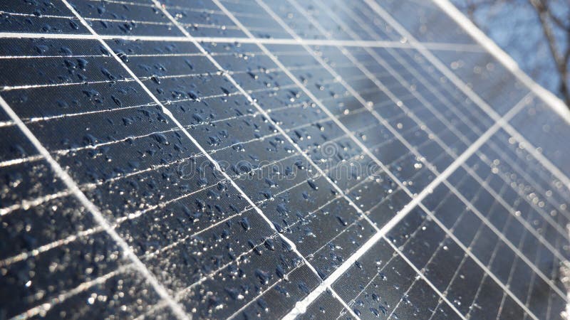 Snow and water drops on the solar panel. Precipitation reduces the generation of electricity from solar cells