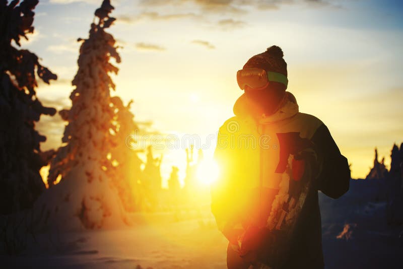 Snowboarder in backlight sunset. Ski resort Sheregesh stock photo