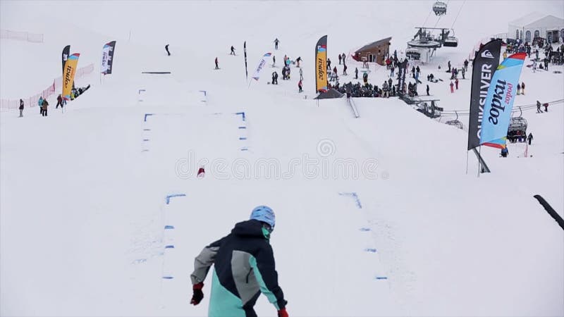Snowboarder en de skiër in eenvormige sprong van springplank, maken extreme tikken in lucht SNEEUW BERGEN
