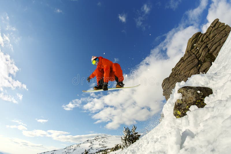 Snowboarder in a jump against the blue sky royalty free stock photography