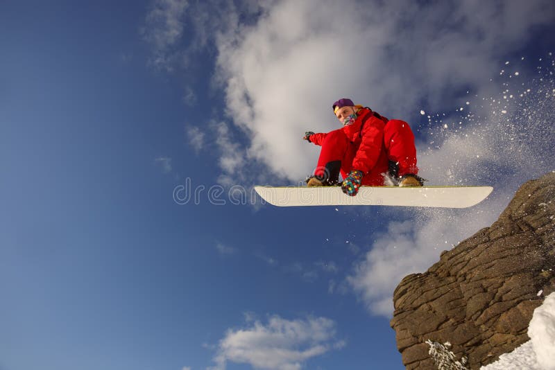 Snowboarder in a jump against the blue sky royalty free stock photos