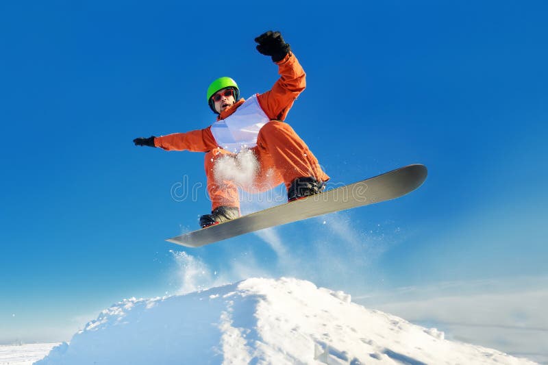 Snowboarder jumping blue sky in background stock photos