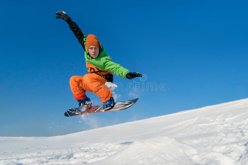 Snowboarder jumping blue sky in background stock photography