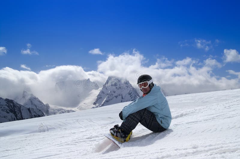 Snowboarder Sitting At Sunset On Relax Moment In French Alps Ski Stock