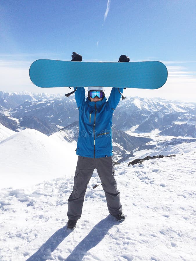 Snowboarder up hold snowboard on top of hill royalty free stock photo Snowboarder up hold snowboard on top of hill royalty free stock photo